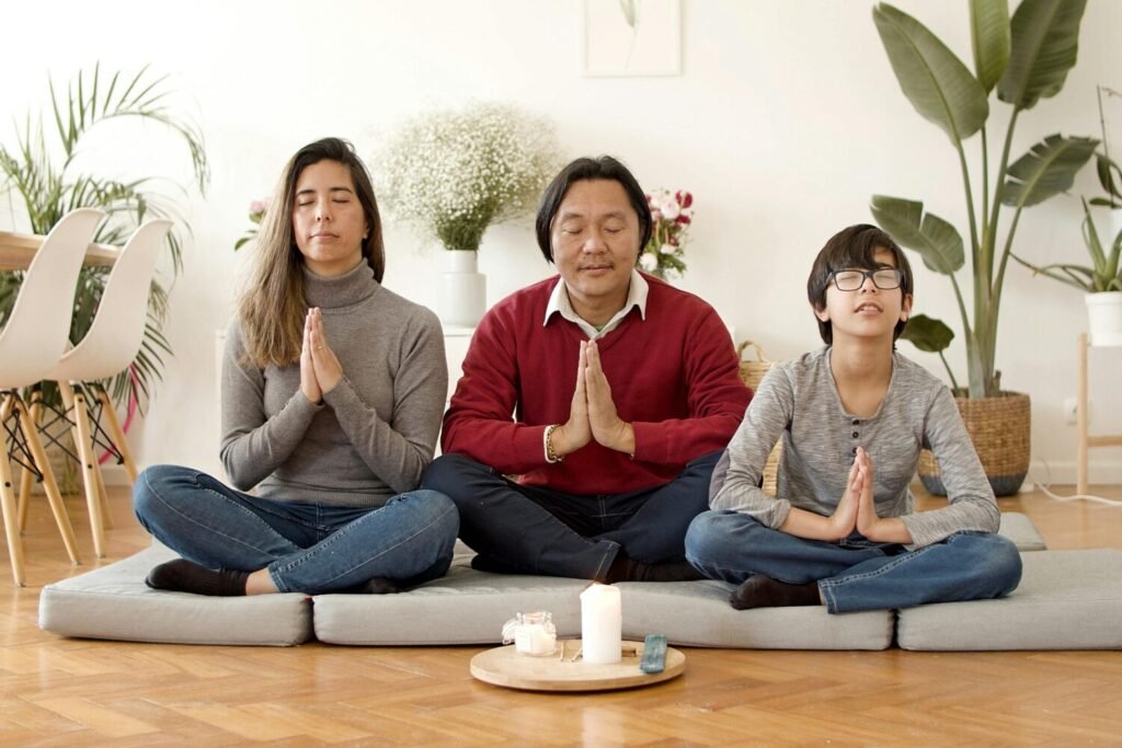 A diverse family meditating together indoors, creating a calm and harmonious atmosphere.